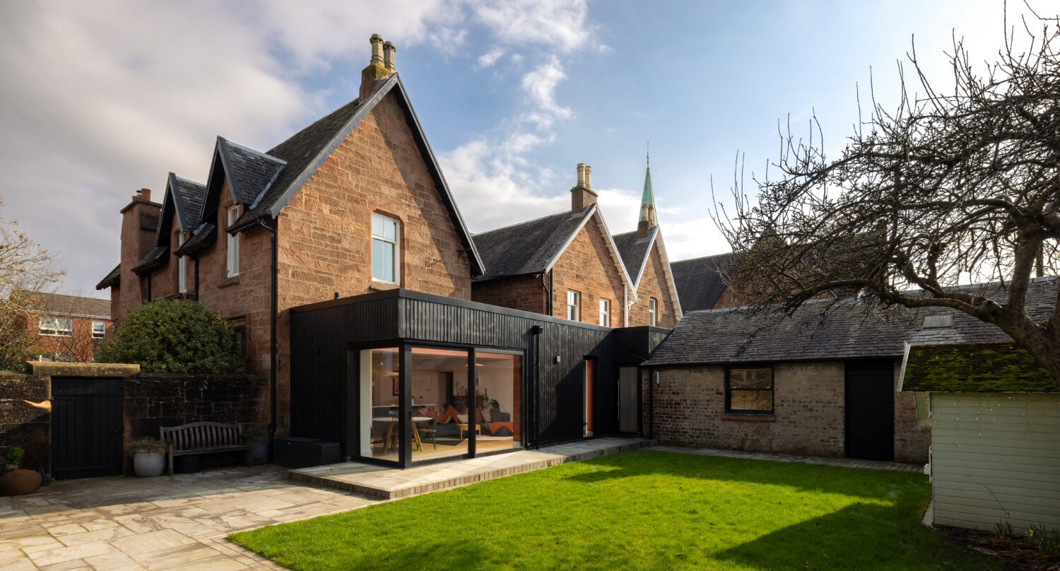 High-quality black bi-folding doors opening to a lush garden in Main Street, Uddingston. Perfect for enhancing natural light and outdoor views with stylish, space-saving design.