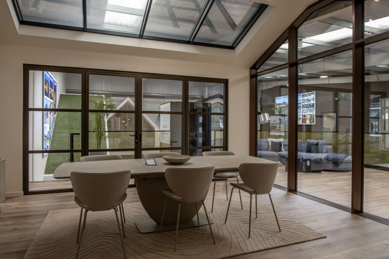 Bright, modern showroom featuring large bi-folding doors with sleek frames, showcasing the latest in bi-fold door designs and installation options at Express Bi-Folding Doors.