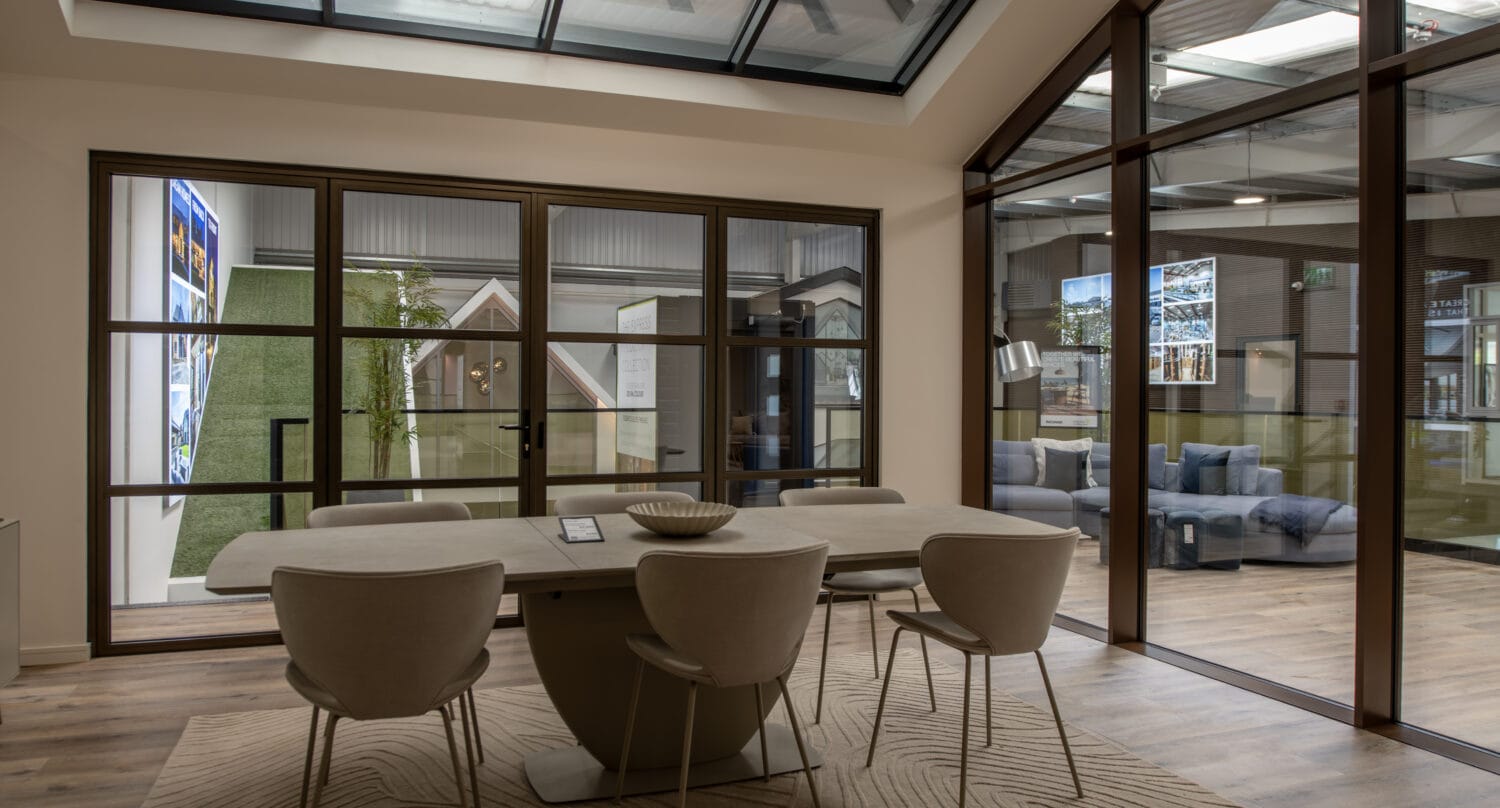 Bright, modern showroom featuring large bi-folding doors with sleek frames, showcasing the latest in bi-fold door designs and installation options at Express Bi-Folding Doors.