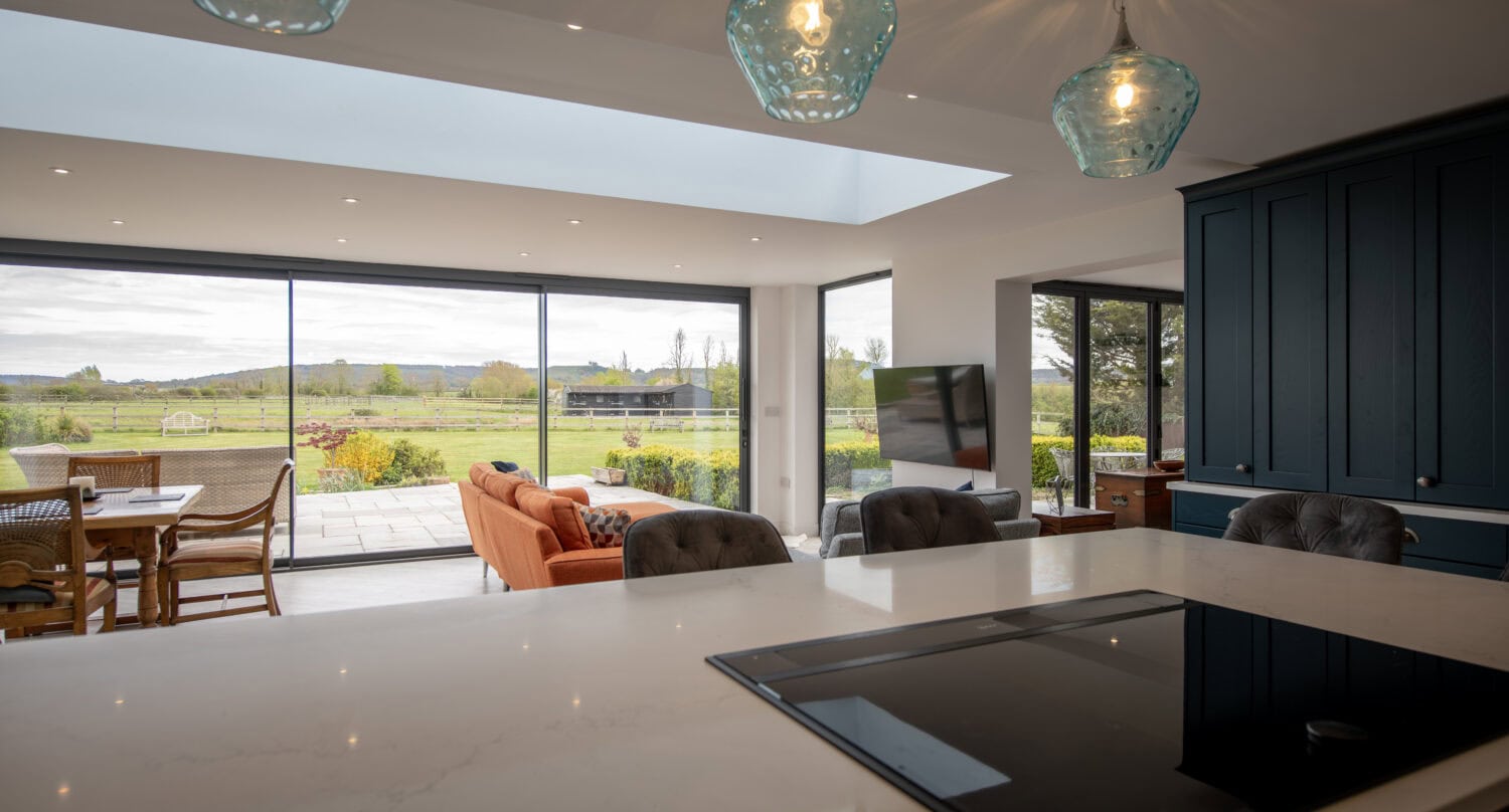 Bi-Folding doors opening to a scenic outdoor view, enhancing natural light and indoor-outdoor flow. Perfect for stylish, functional home improvements.