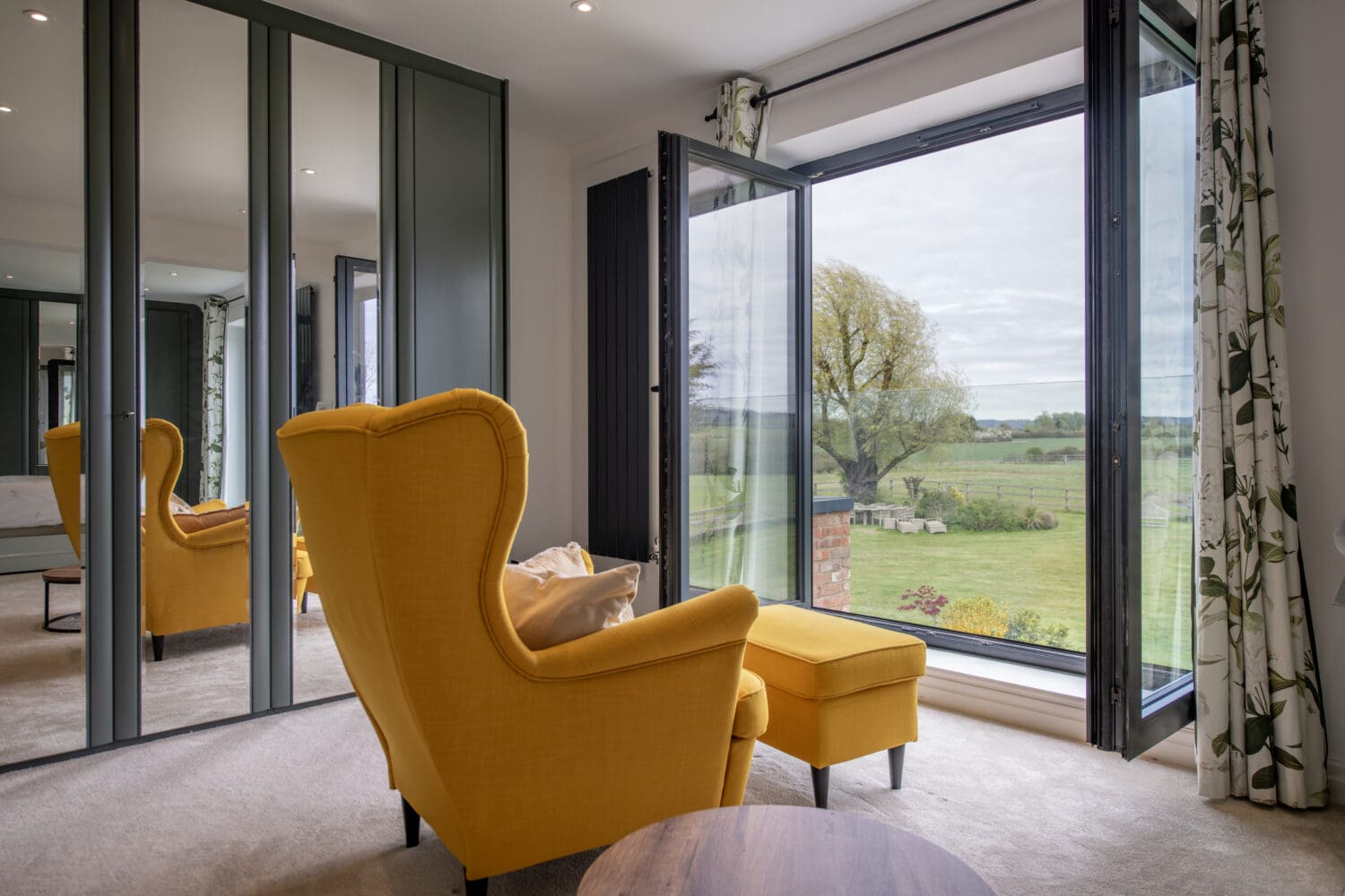 Auto Draft - Express Bi-Folding Doors with large glass panels opening to scenic outdoor views. Perfect for enhancing natural light and indoor-outdoor living spaces.