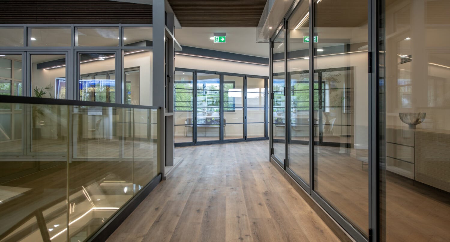 Modern interior of the new Express Bi-Folding Doors showroom in Milton Keynes, showcasing sleek glass bi-fold doors and contemporary design.