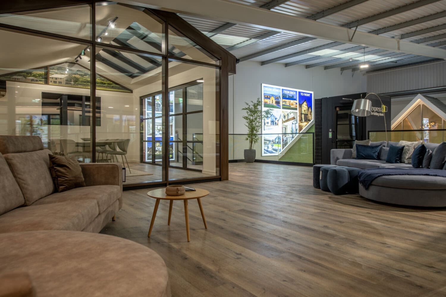 Modern showroom featuring Express Bi-Folding Doors with large glass panels, showcasing stylish indoor-outdoor living solutions in Milton Keynes.