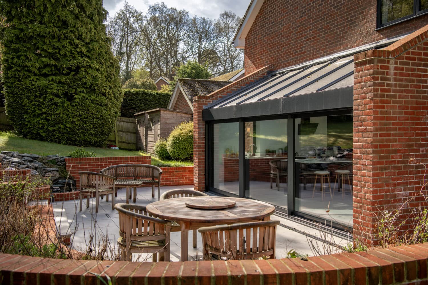 High-quality sliding bi-fold doors opening to a stylish outdoor patio.
