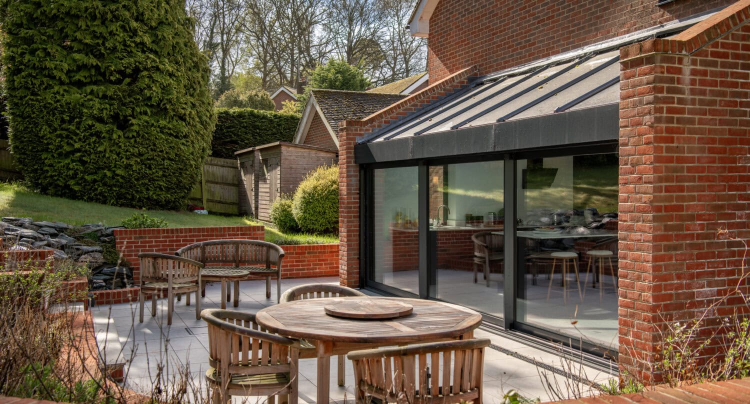 High-quality sliding bi-fold doors opening to a stylish outdoor patio.