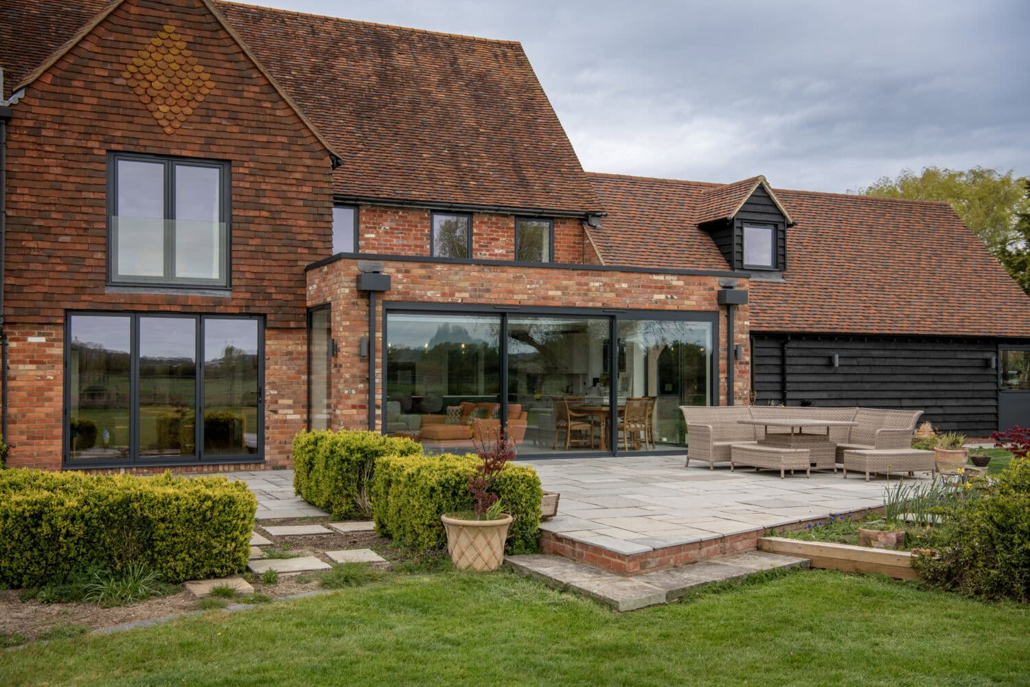 Modern glass bi-folding doors installed in a residential home, providing seamless indoor-outdoor living space and enhancing natural light.