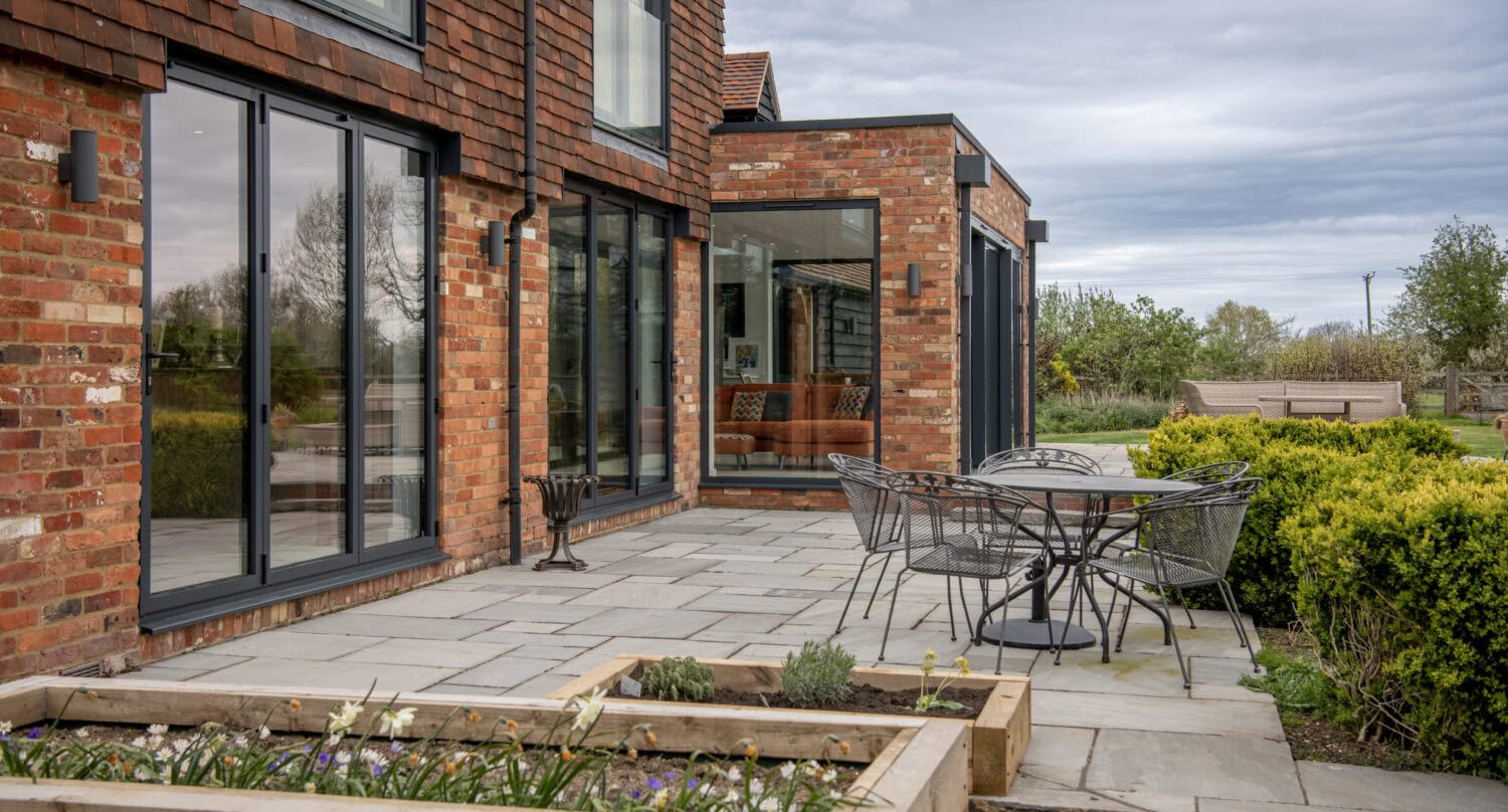 High-quality bi-folding doors installed in a modern brick home.