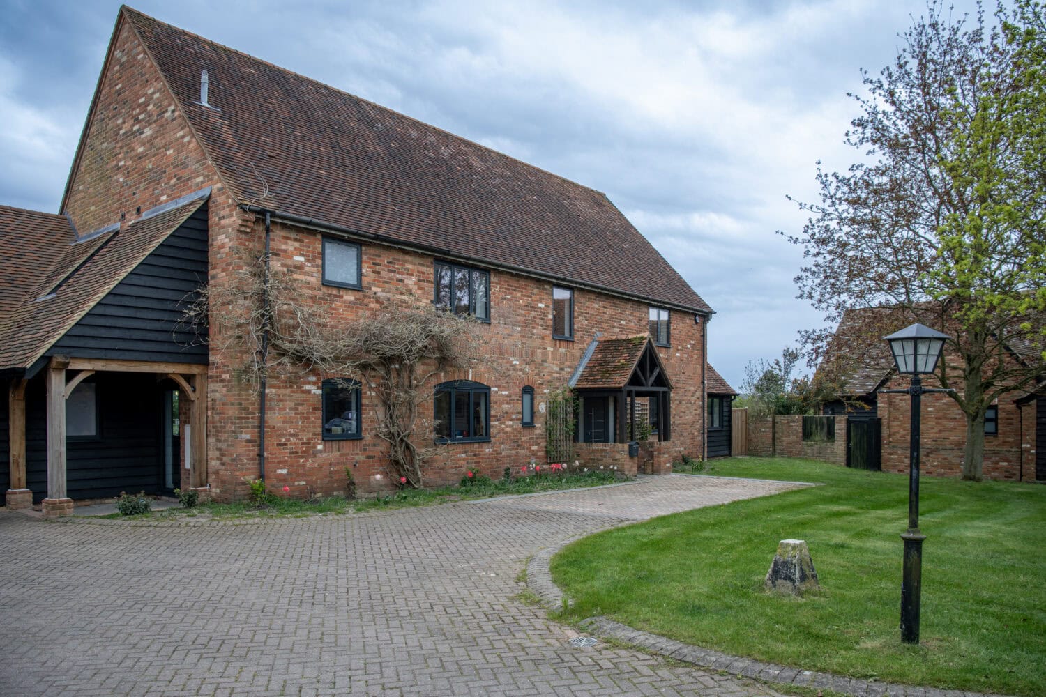 Bi-folding doors opening to a garden in a traditional brick house.