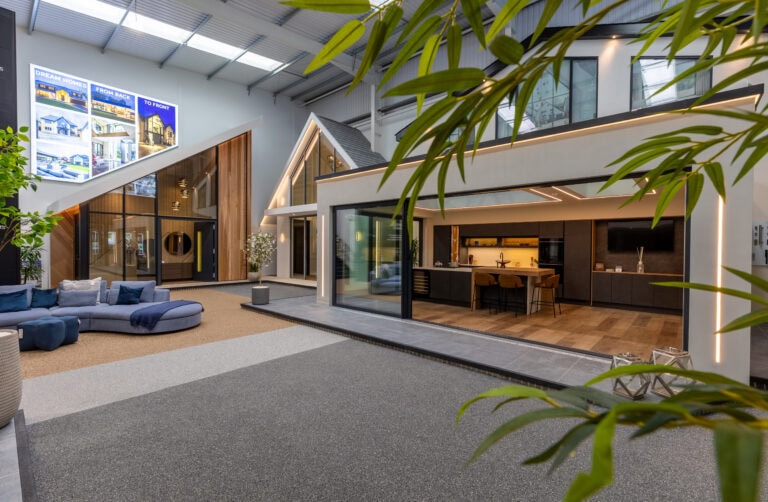 Elegant Milton Keynes showroom featuring modern bi-folding doors that seamlessly connect indoor and outdoor living spaces, showcasing high-quality aluminium designs.