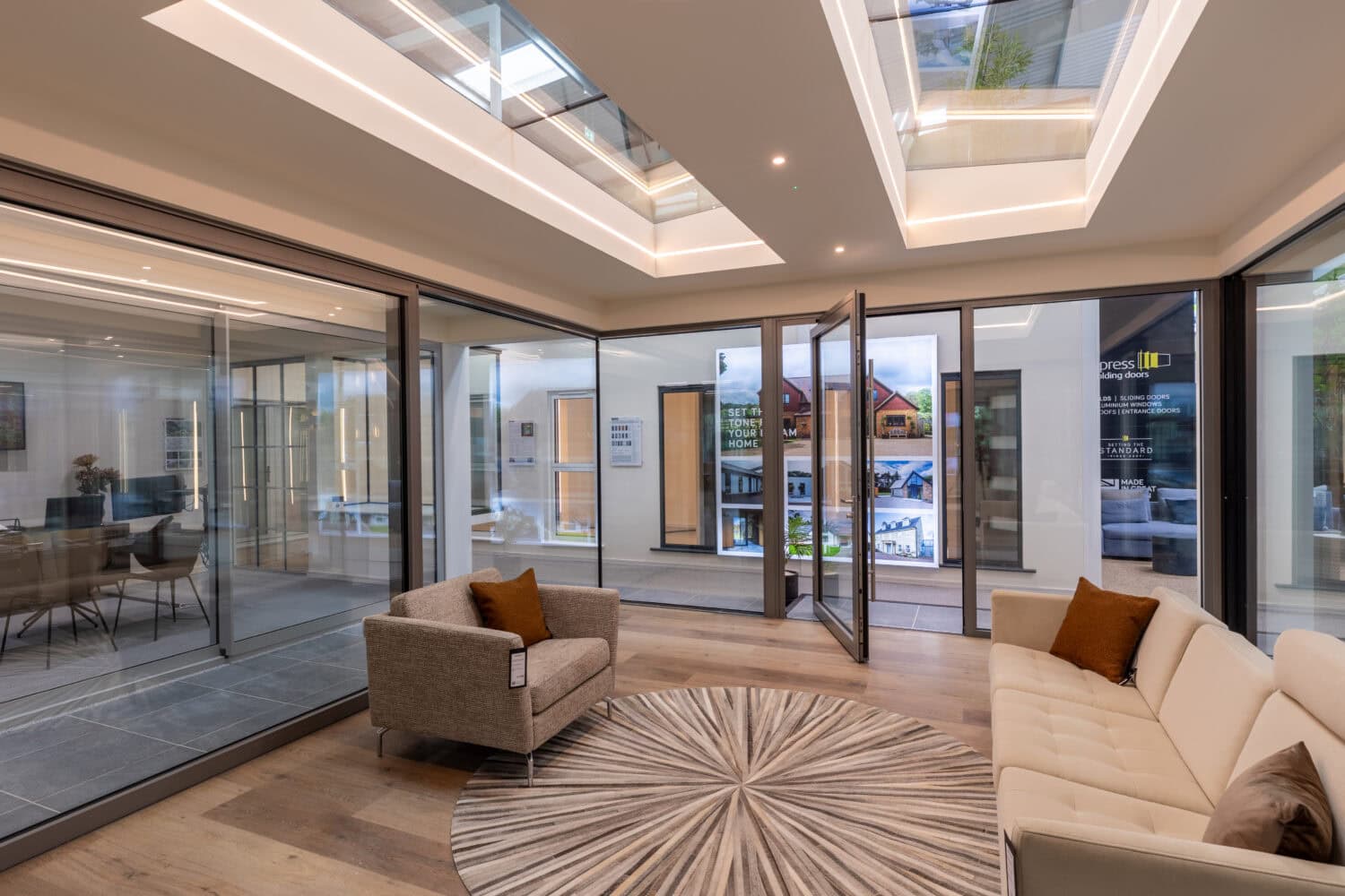 An elegant Milton Keynes showroom featuring modern bi-folding doors that open to outdoor spaces, showcasing high-quality, energy-efficient designs perfect for contemporary homes.