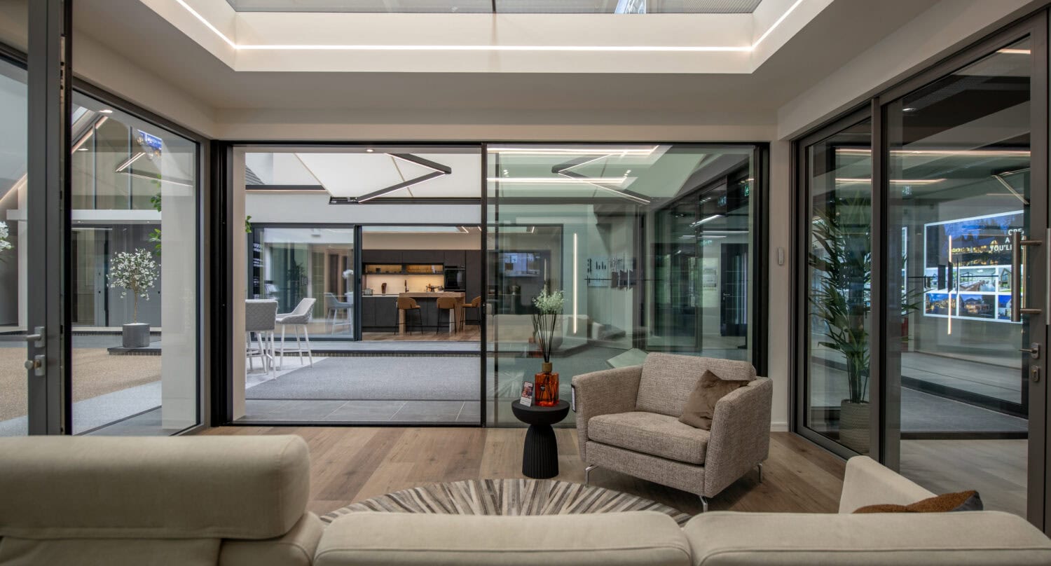 Modern Milton Keynes showroom featuring large bi-folding glass doors opening to an outdoor patio area, showcasing stylish interior design and seamless indoor-outdoor living.