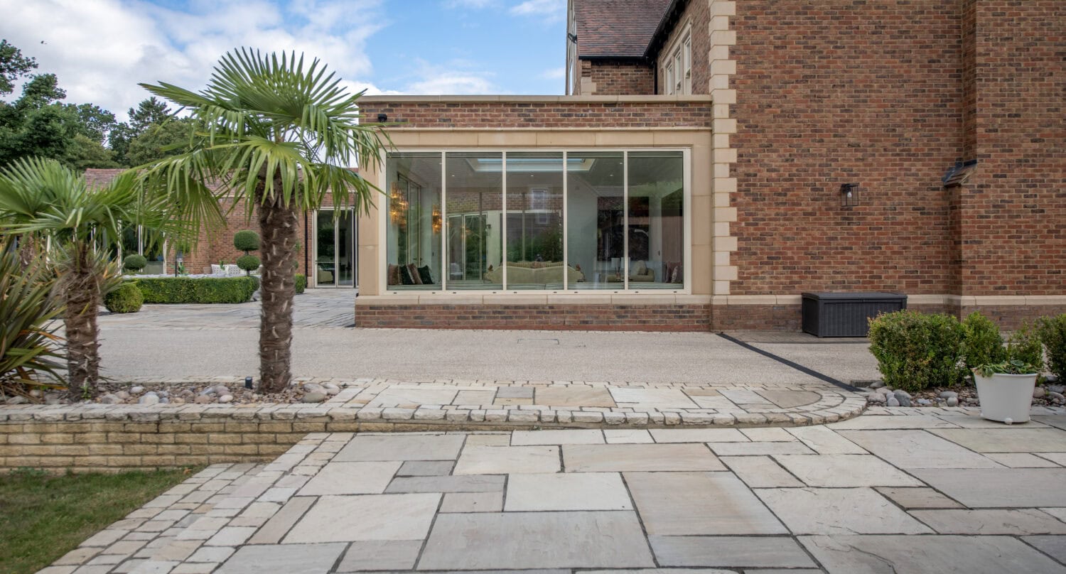 Modern glass bi-folding doors installed at Foxwood House, providing seamless indoor-outdoor living space with natural light and contemporary style.