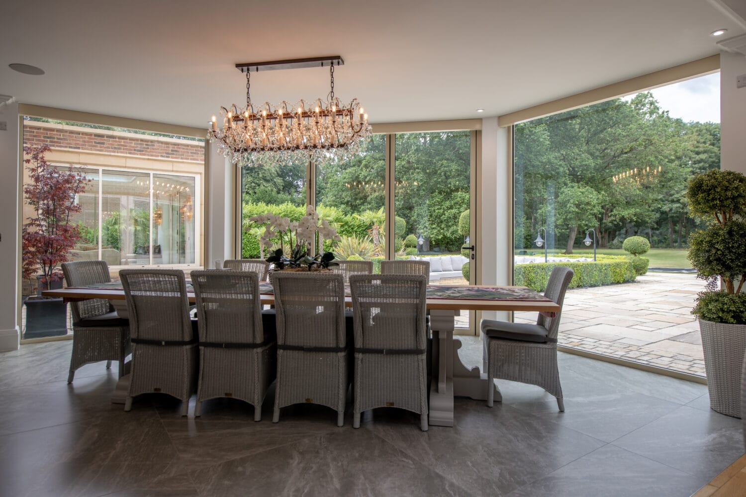 Elegant bi-folding doors opening to a lush garden, providing natural light and seamless indoor-outdoor living at Foxwood House.