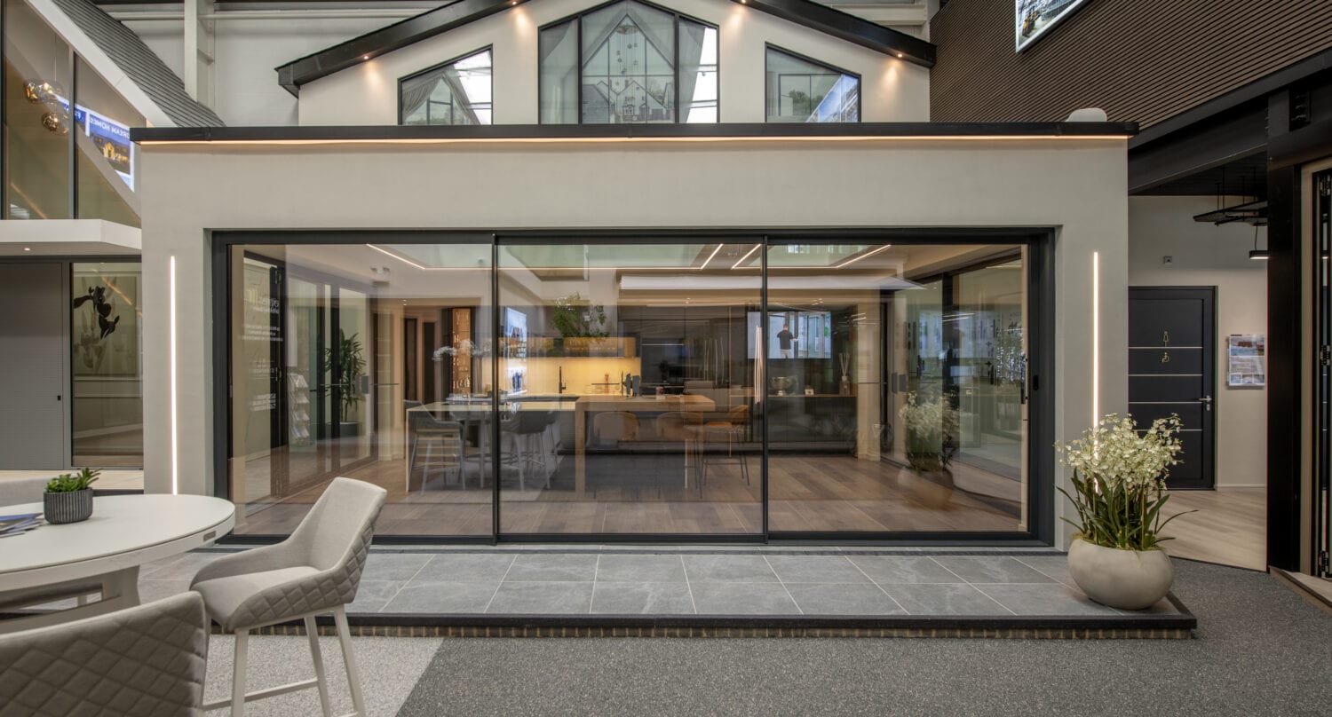 Modern Milton Keynes showroom featuring large bi-folding glass doors opening to an indoor space, showcasing contemporary design and natural light.