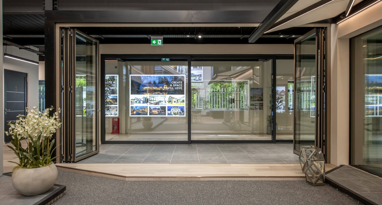 Modern bi-folding doors at Milton Keynes showroom, showcasing seamless indoor-outdoor transition and contemporary design.