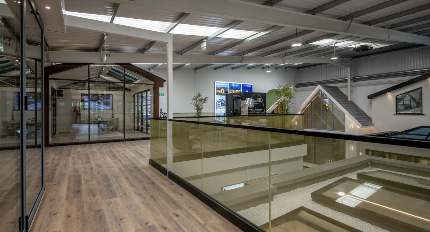 Modern Milton Keynes showroom featuring large bi-folding doors and spacious interior with wooden flooring and glass partitions.