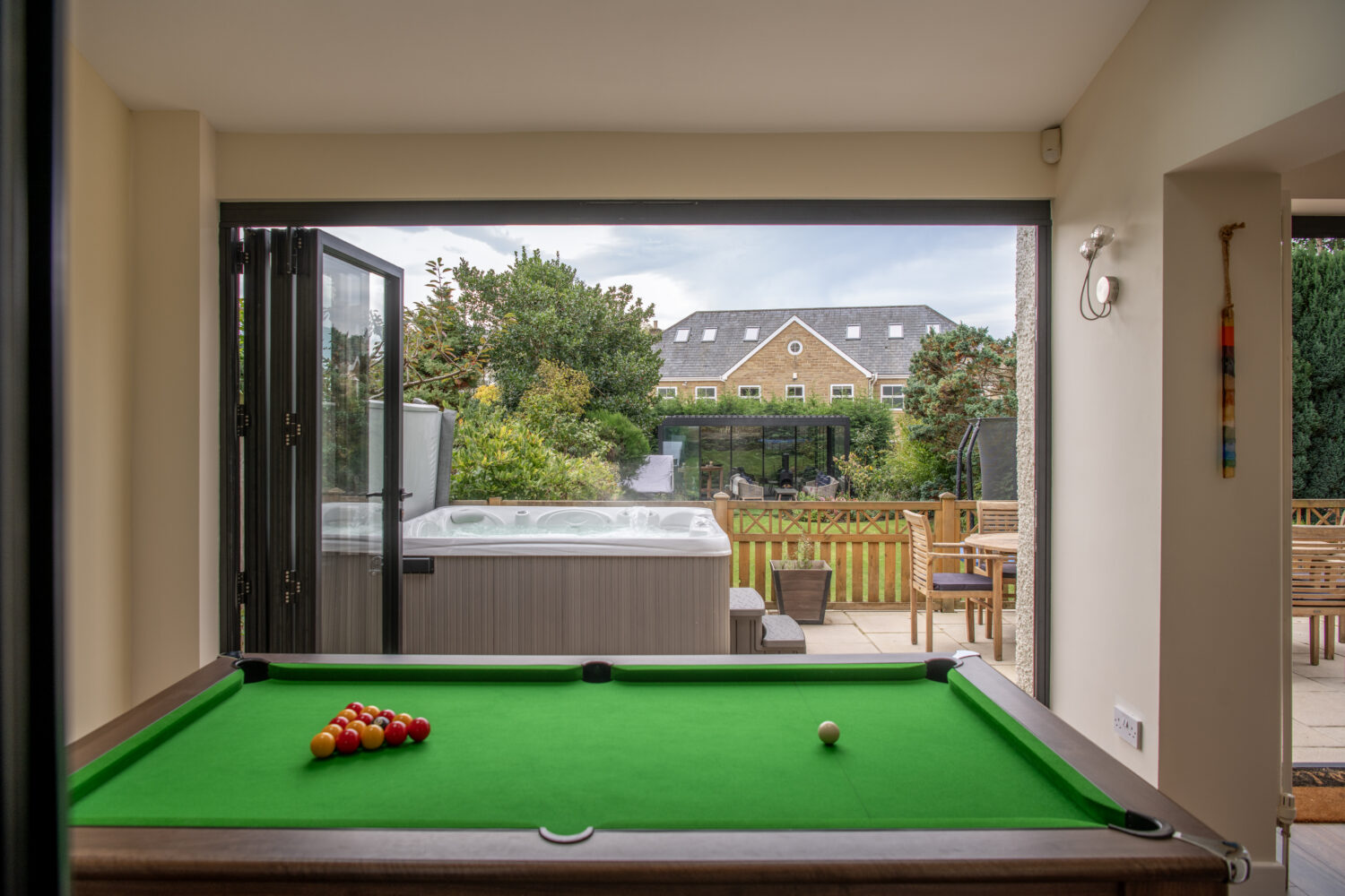 Modern bi-folding doors opening to a garden patio, enhancing outdoor living space with natural light and seamless indoor-outdoor transition.